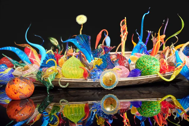 A display of glass from Dave Chihuly in a wooden boat