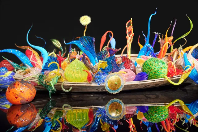 A display of glass from Dave Chihuly in a wooden boat